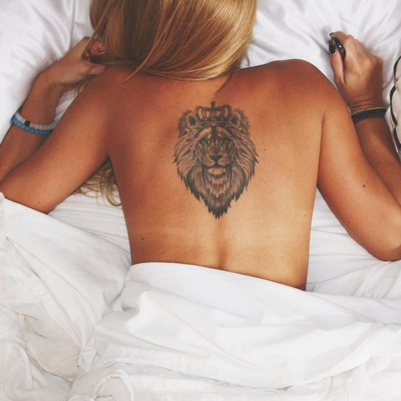 Women in Bed with Leo Tattoo on Full Back